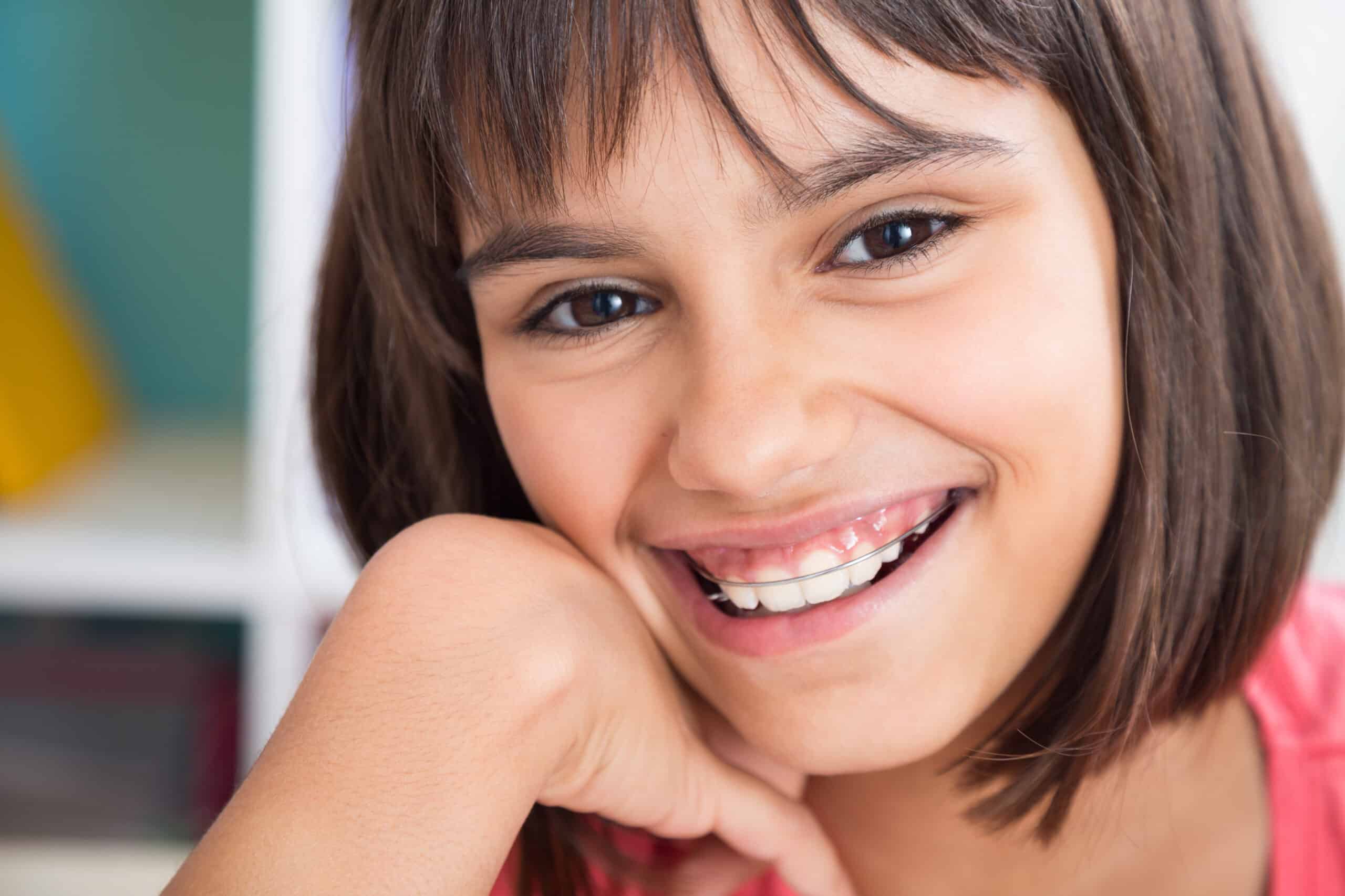 Girl wearing a retainer for post-orthodontic care