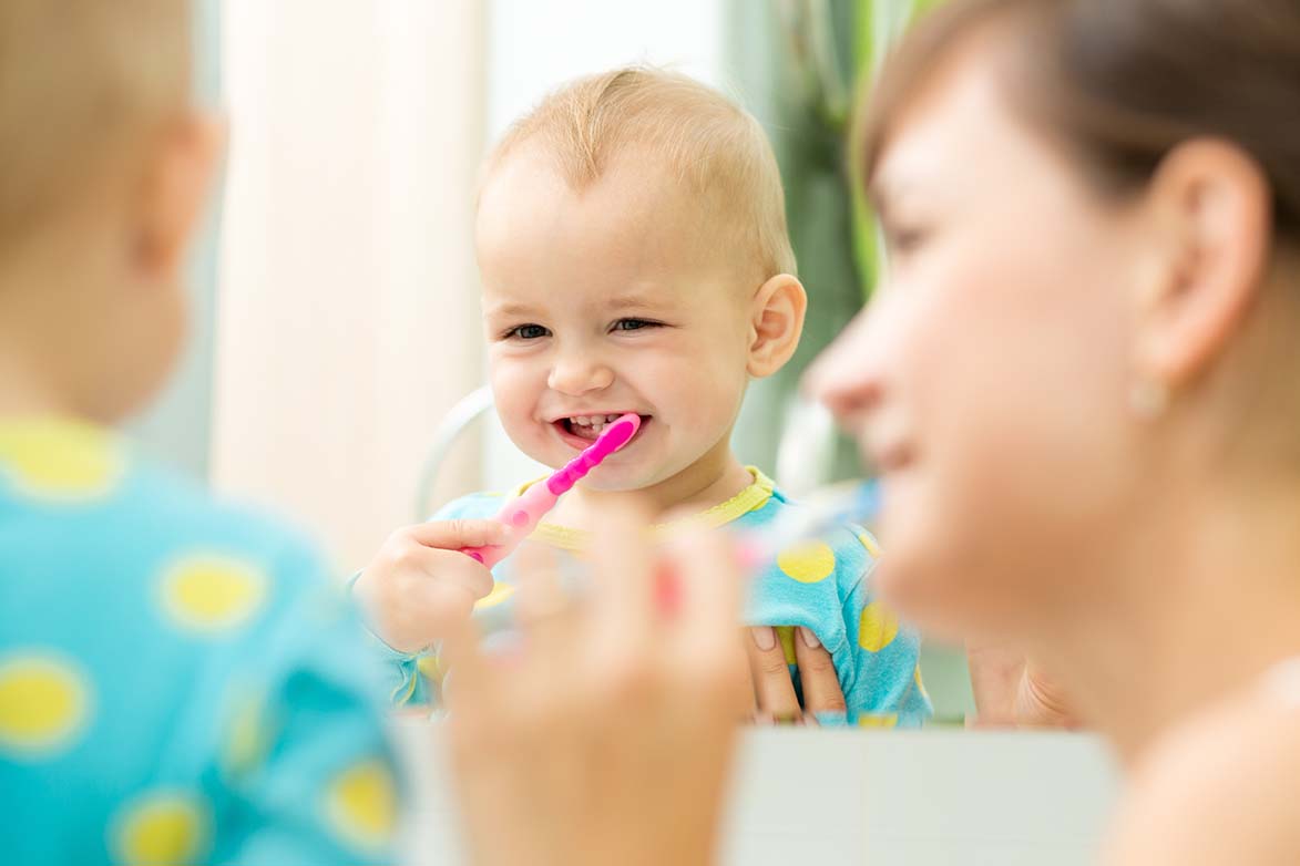 Mother and daughter doing dental care