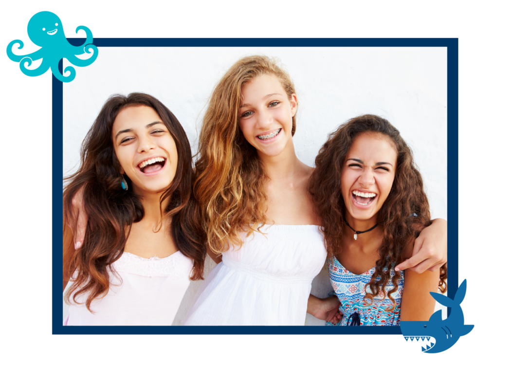Group of teenage girls with perfect teeth laughing and smiling