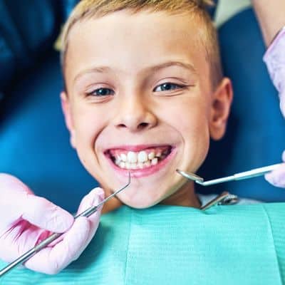 Happy young boy undergoing early orthodontic treatment