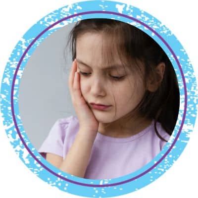 Little girl holding her jaw in pain