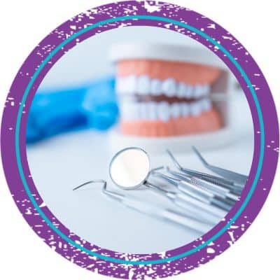 Artificial teeth with dental tools in front of them