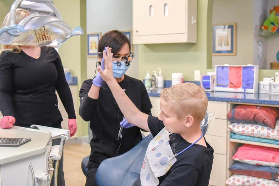 Dr-kim-high-fiving-adolescent-dental-patient Orthodontic consultation