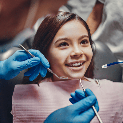 Little girl smiling at the dentist, representing dental issues in children