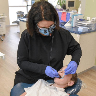 Stevenson ranch 2 Dr. Kathleen mulcahey working on a kid's teeth, representing the best age for dental checkup